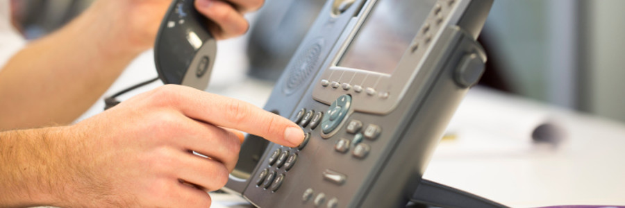 a man dialing on a voip phone