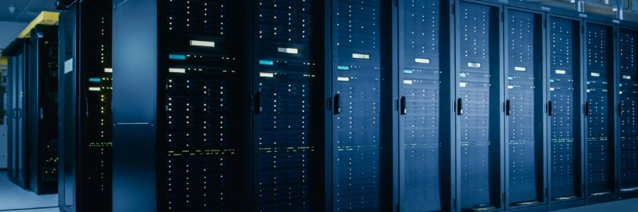 A photograph of a server room. There are several rows of these servers.